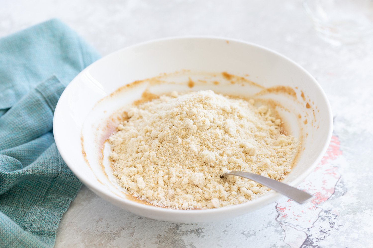 Snickerdoodle bites oat flour and ground nuts being mixed with nut butter for making snack bites
