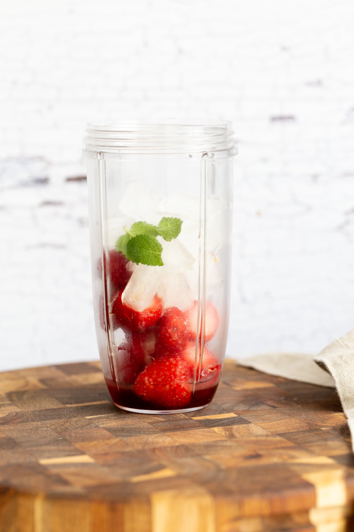 lemonade slushie ice cubes fresh mint and frozen strawberries in a blender