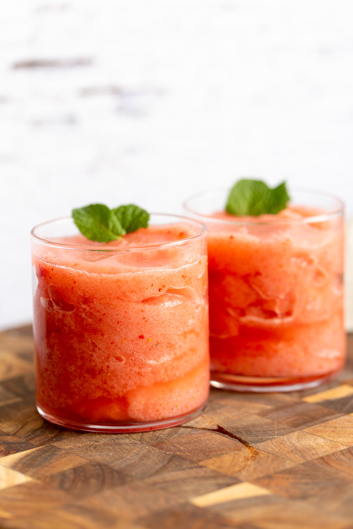 lemonade slushies  two glasses with homemade vegan strawberry lemonade slushies
