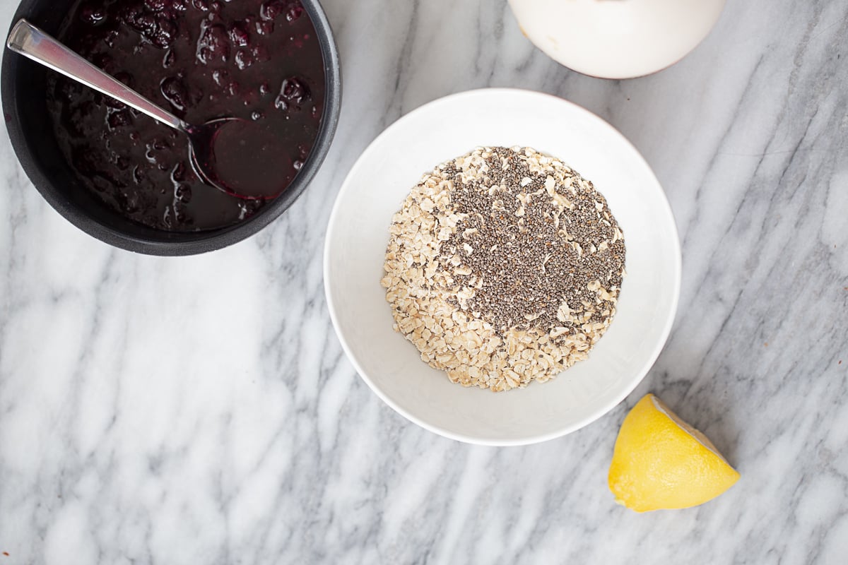 blueberry overnight oats overhead shot of two bowls, one with oats and chia seeds, one with blueberry compote