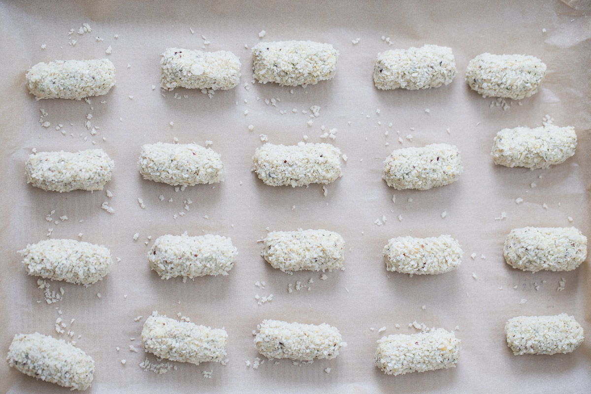 vegan croquettes unbaked vegan quinoa chickpea croquettes rolled in breadcrumbs on a baking sheet