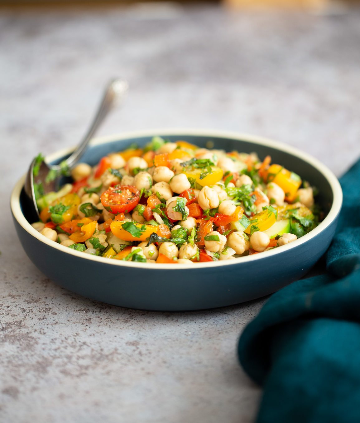 Mediterranean Chickpea Salad side view of a dish of Mediterranean vegan chickpea salad with lemon garlic dressing