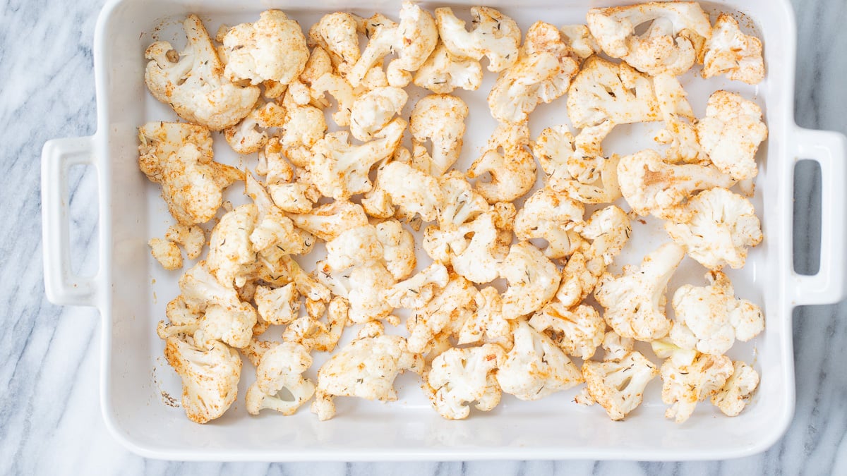 cauliflower salad  cauliflower florets sprinkled with bbq spices ready for roasting