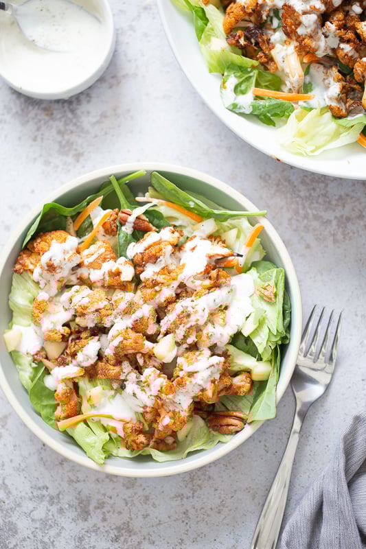cauliflower salad overhead shot of a bbq roasted cauliflower salad bowl drizzled with Vegan Ranch Dressing