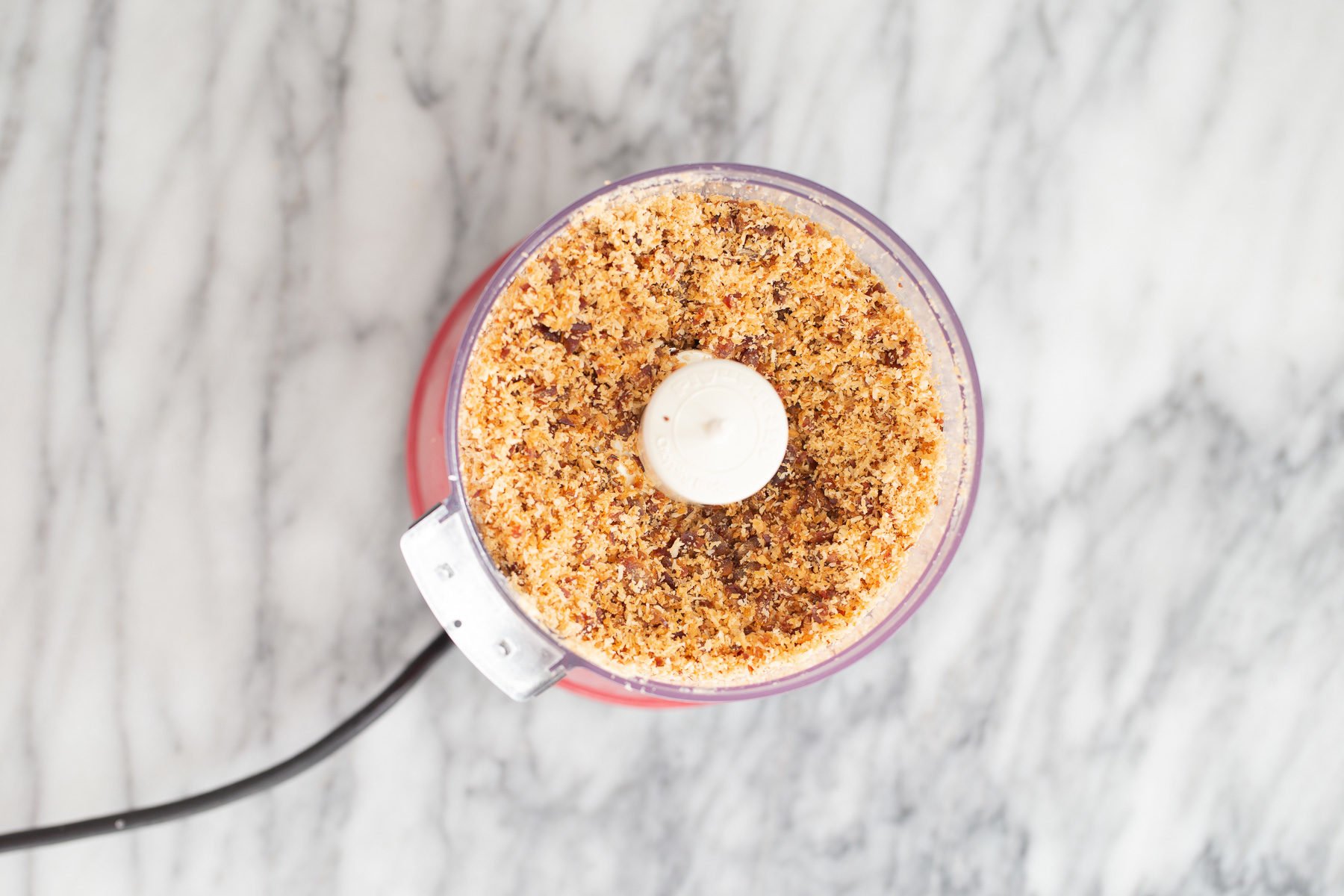 vegan date bars  shredded coconut being blended with dates