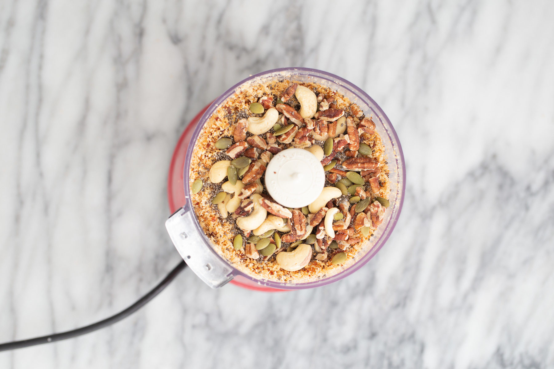 vegan date bars  shredded coconuts, nuts, seeds and dates in a food processor