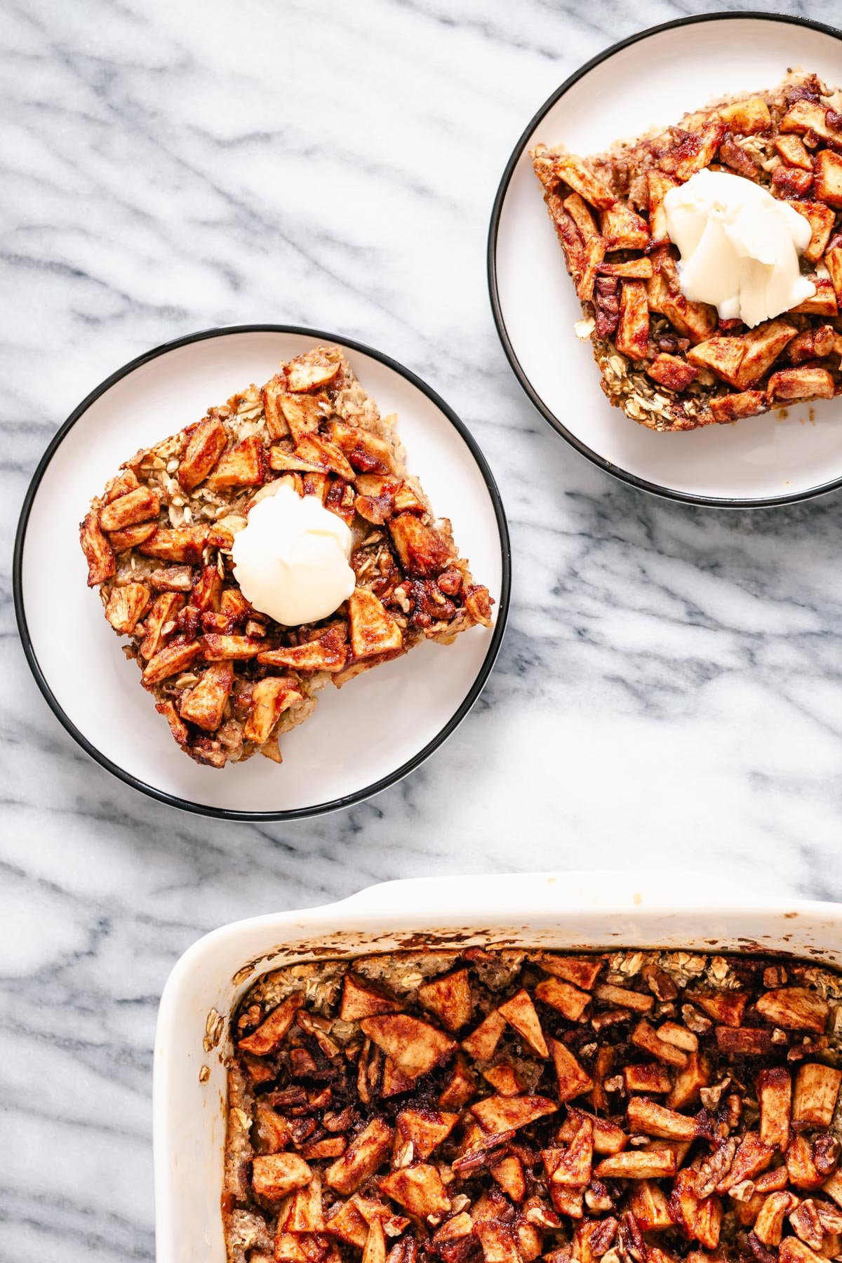 apple pie baked oatmeal two squared of apple pie baked oatmeal served on cake plates