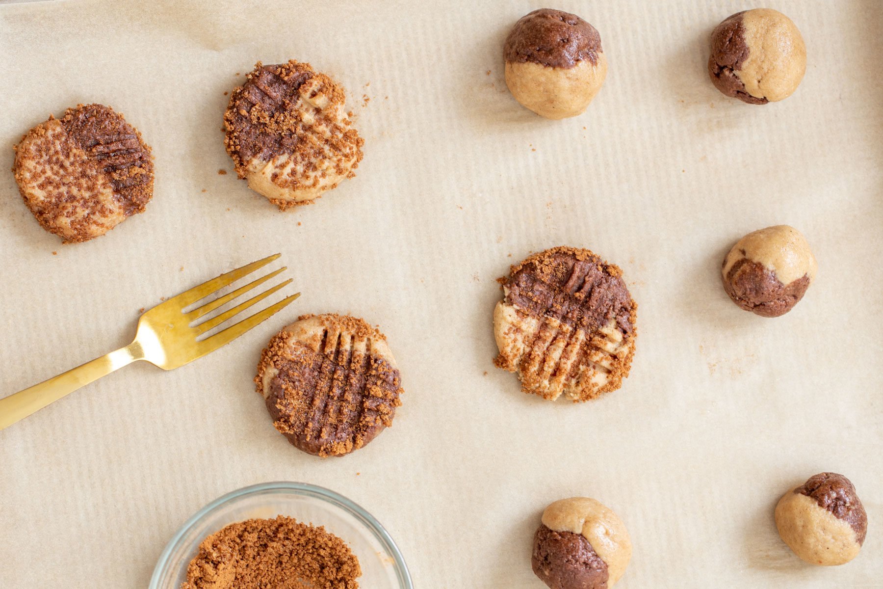 vegan snickerdoodles vegan pumpkin spice snickerdoodle cookies being placed on a cookie sheet before baking