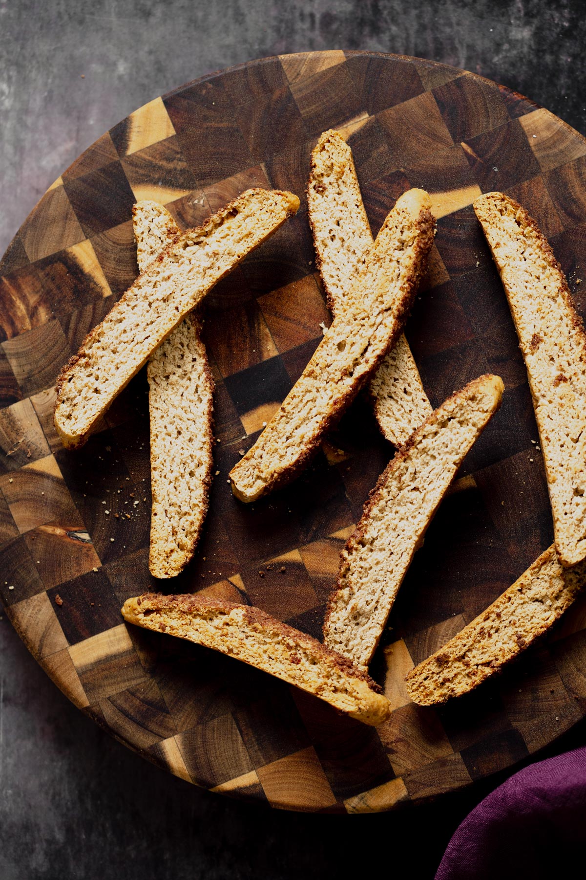 vegan biscotti  overhead shot of vegan cinnamon sugar biscotti on a wooden plate