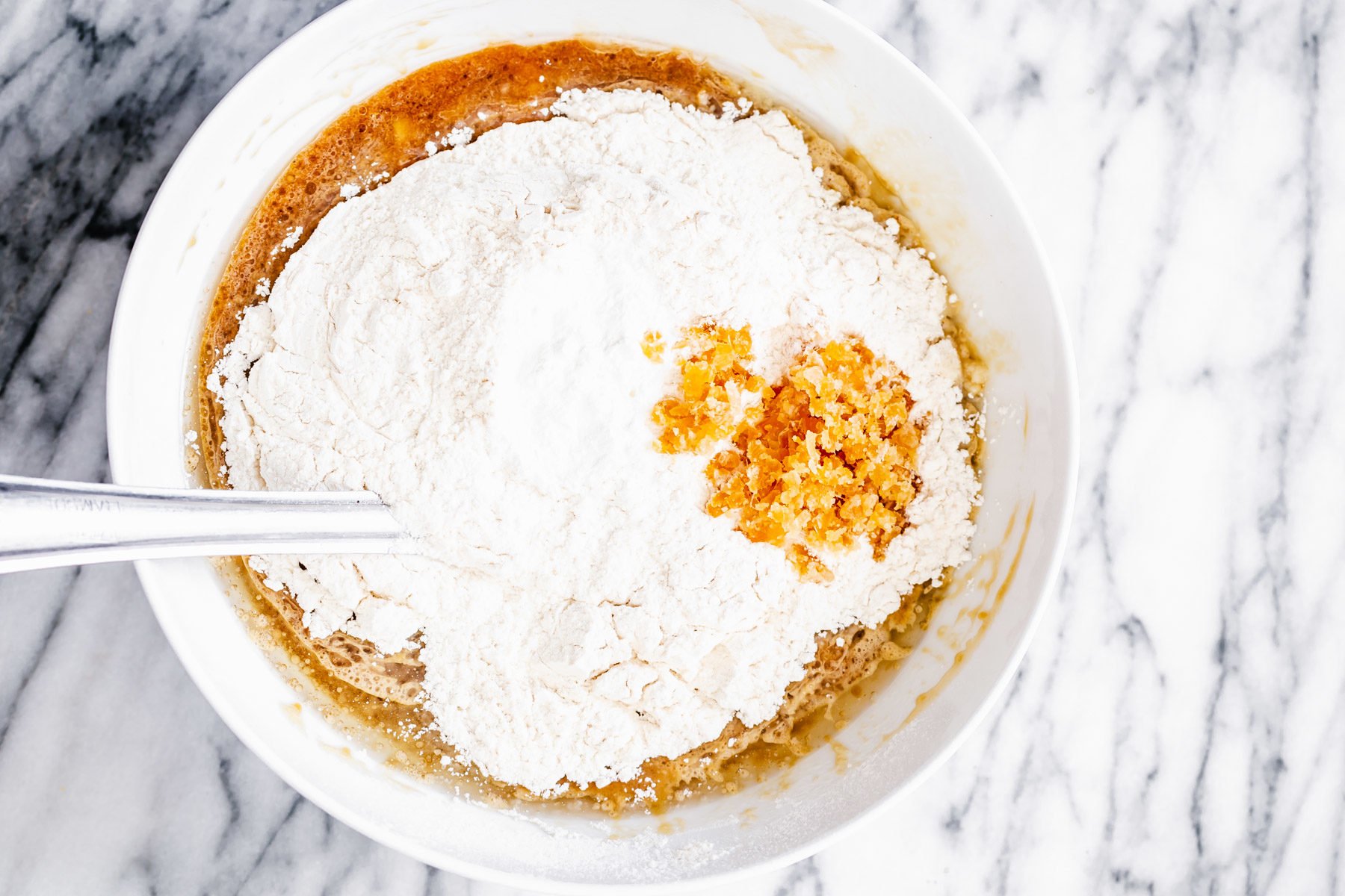 gingerbread banana bread flour being added to wet batter ingredients