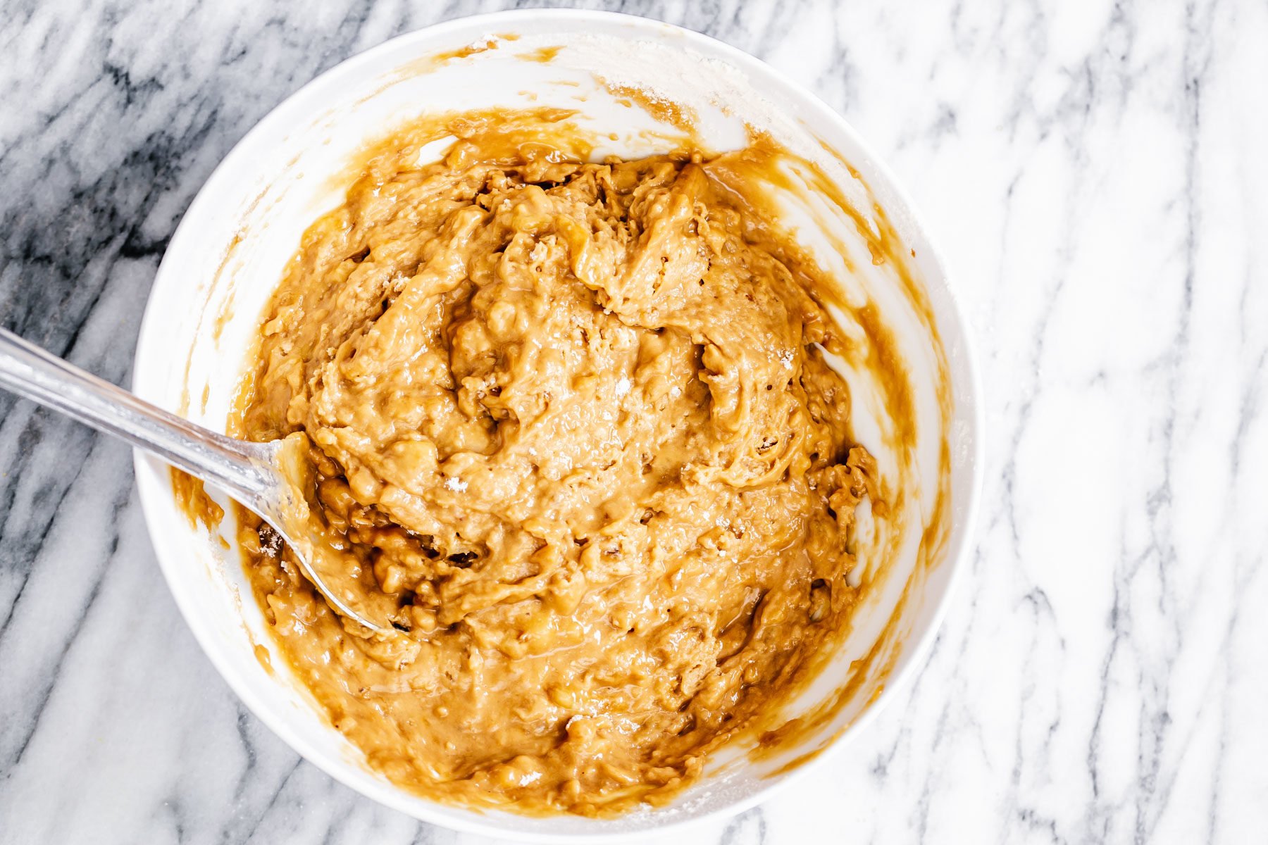 gingerbread banana bread vegan gingerbread banana bread batter in a white bowl