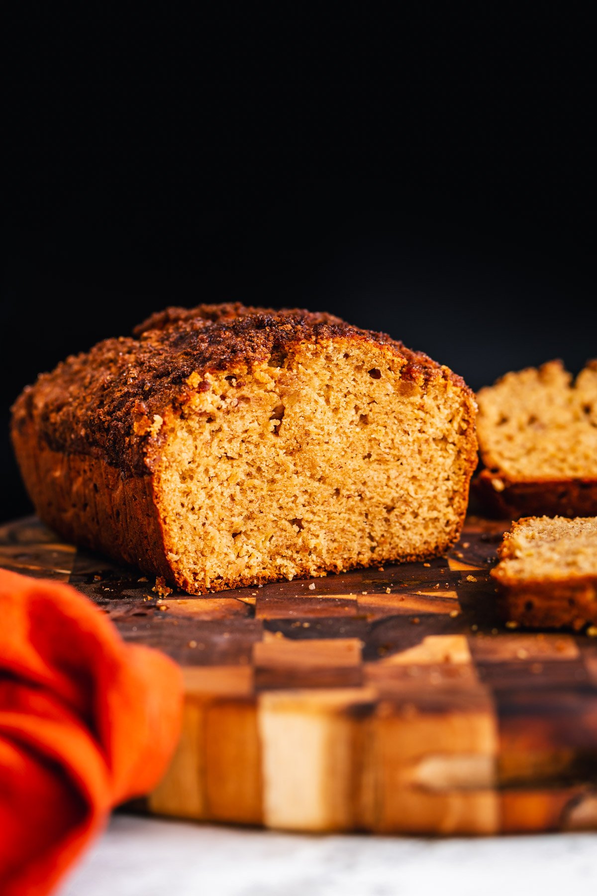 Sliced vegan gingerbread banana bread on a wood board