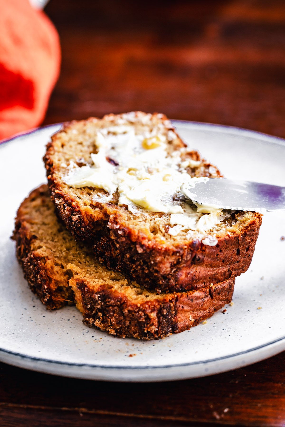 gingerbread banana bread two stacked slices of vegan gingerbread banana bread slathered with butter