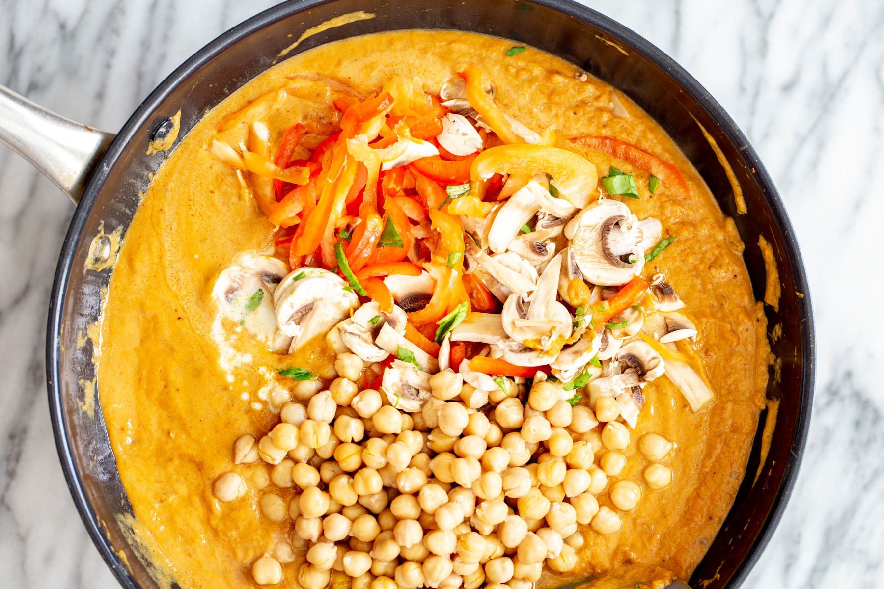 pumpkin curry  veggies being added to pumpkin curry base