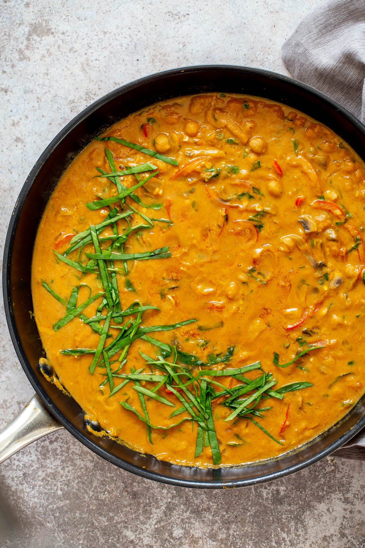 pumpkin curry  overhead shot of a skillet with pumpkin chickpea curry