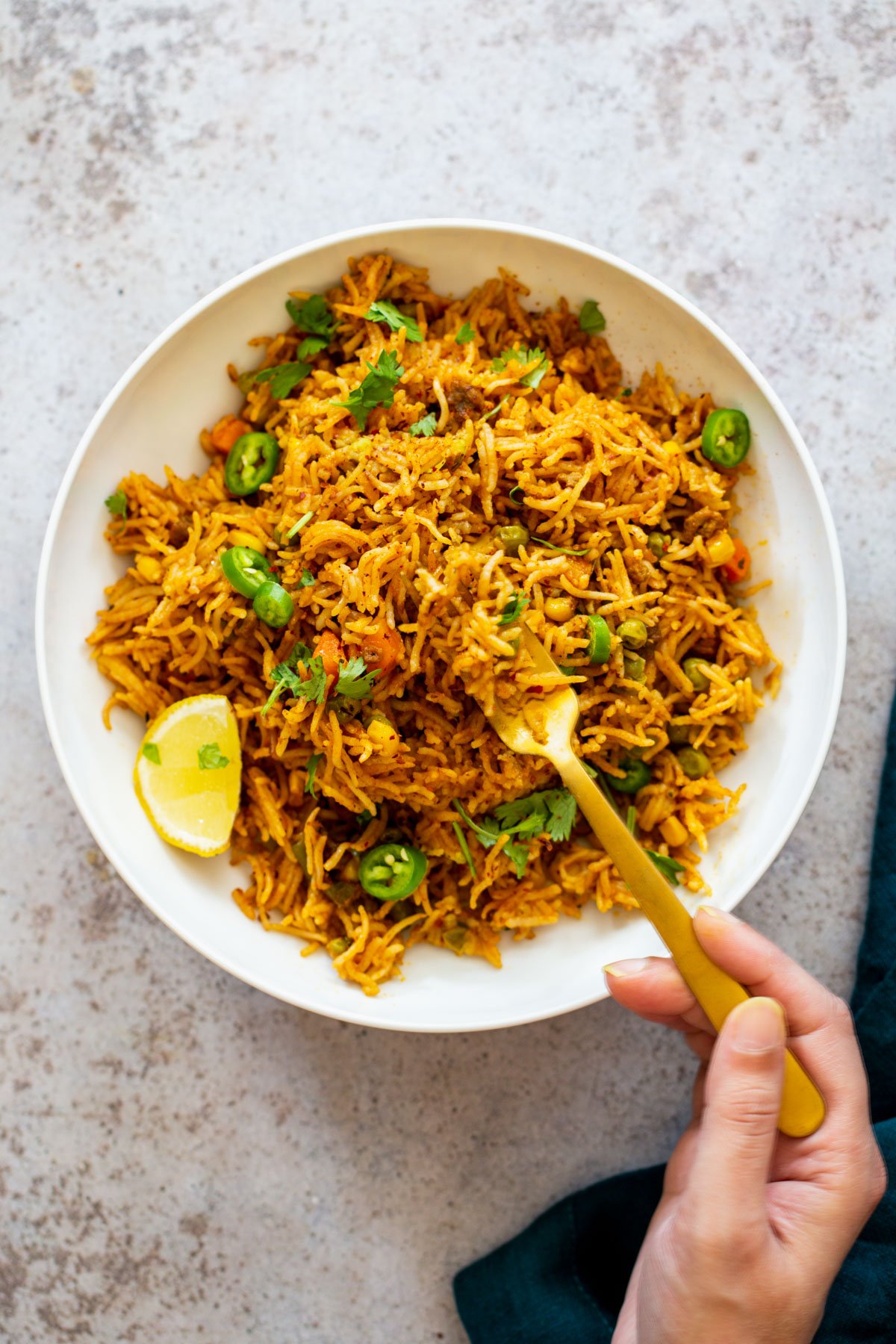 Instant Pot Fried Rice  a fork digging into a pile of fluffy chipotle pumpkin fried rice