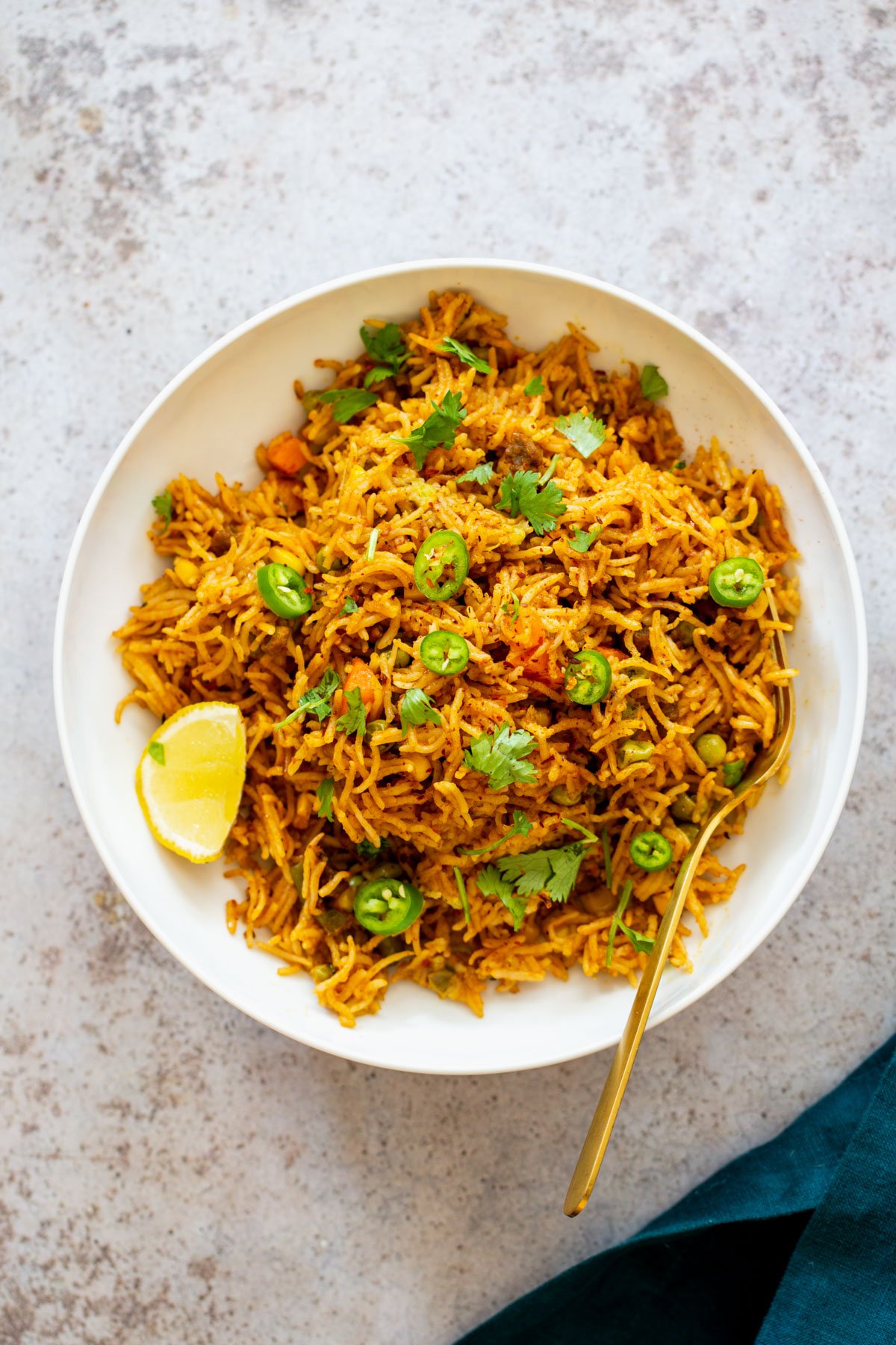 Instant Pot fried rice overhead shot of a plate of vegan pumpkin fried rice served with lime and sliced jalapenos