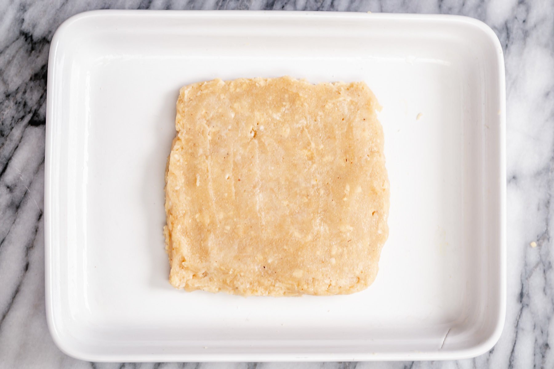 rasmalai cake  rasmalai cake batter being shaped to a square in a pan