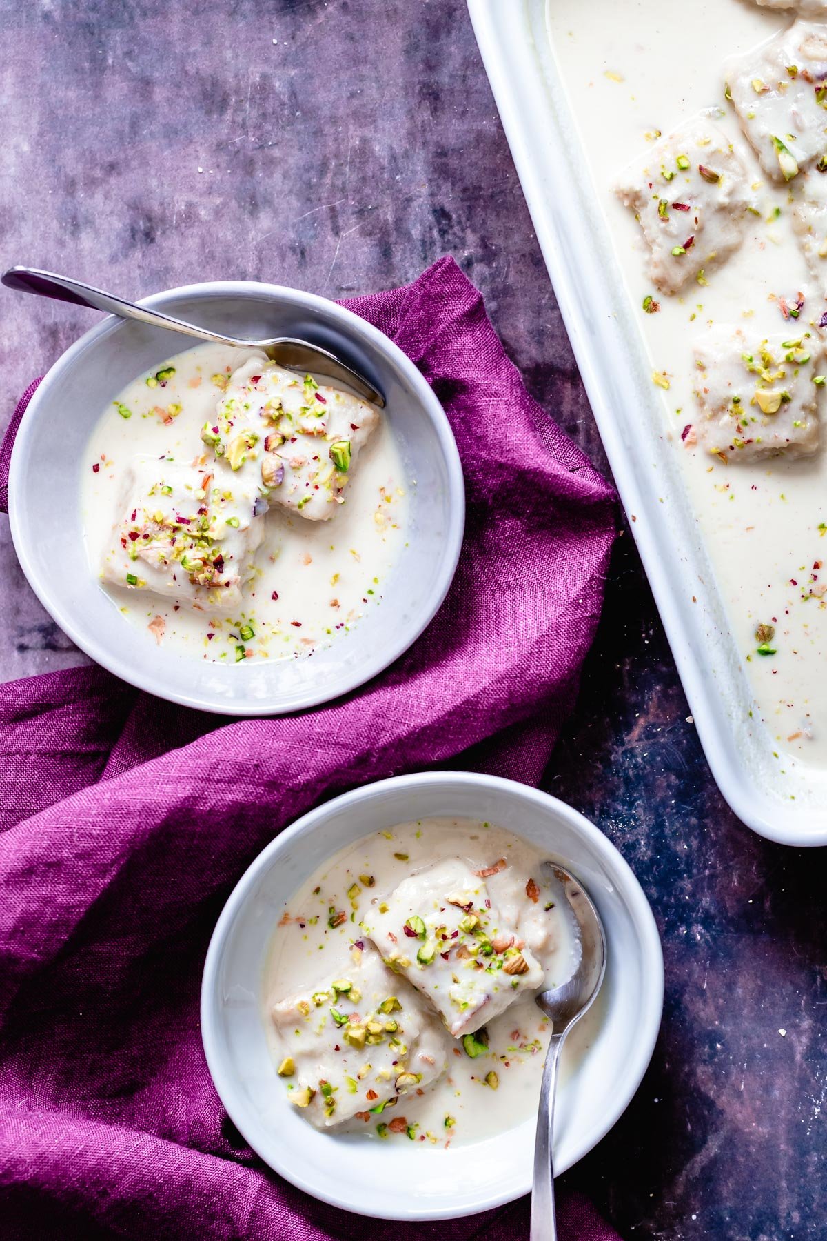 rasmalai cake two small bowl of vegan rasmalai cake immersed in vegan nut milk sauce