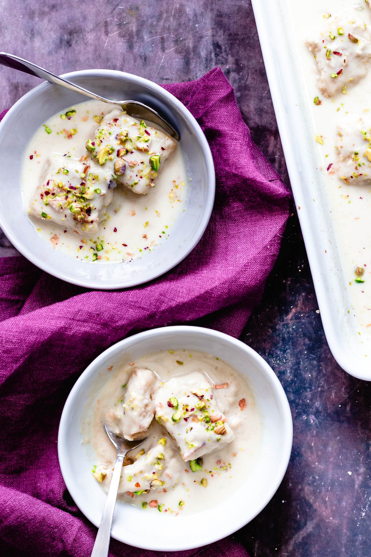 rasmalai cake  overhead shot of two servings of vegan rasmalai cake