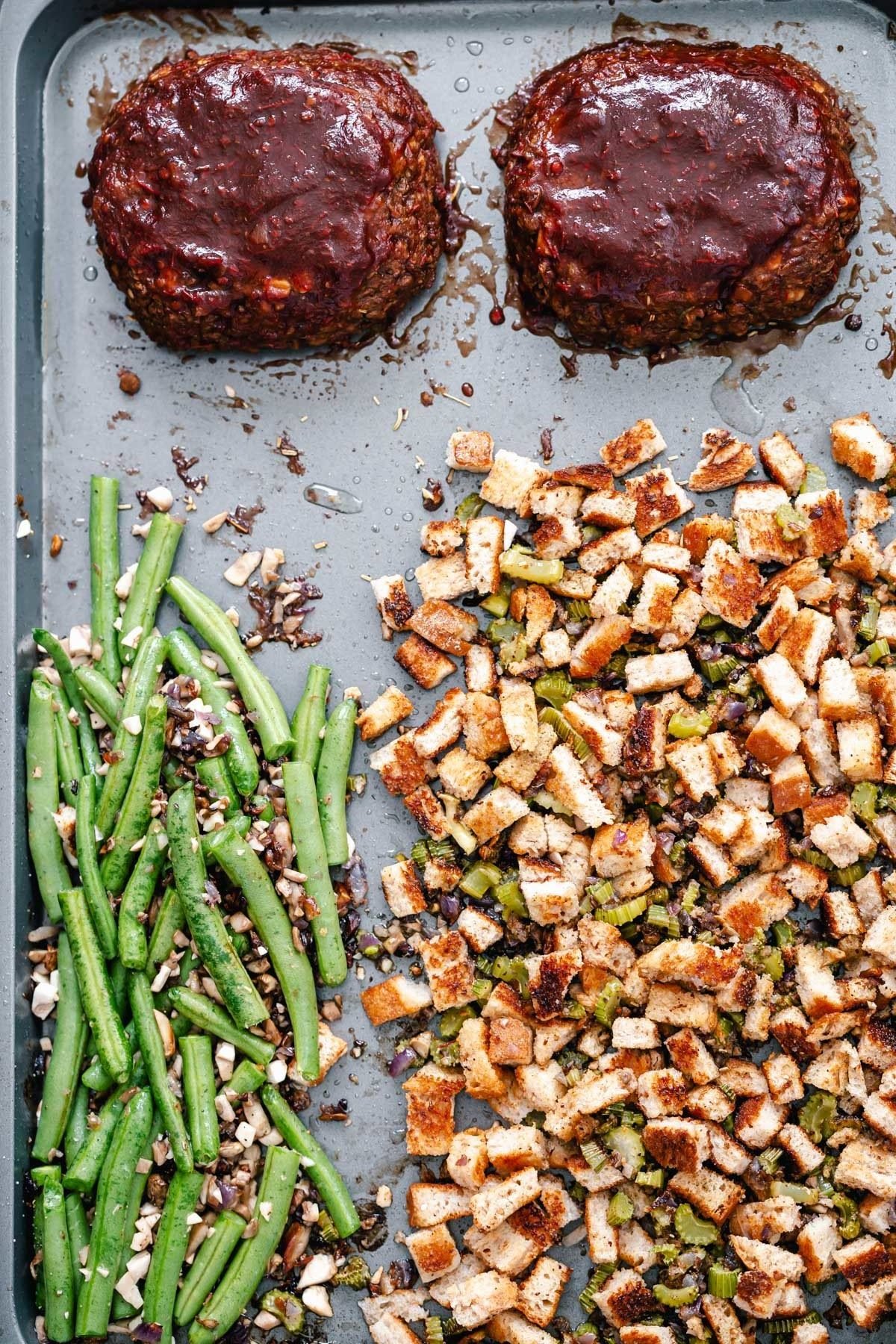 Thanksgiving sheet pan dinner Thanksgiving sheet pan dinner - green beans and stuffing next to two lentil loaves