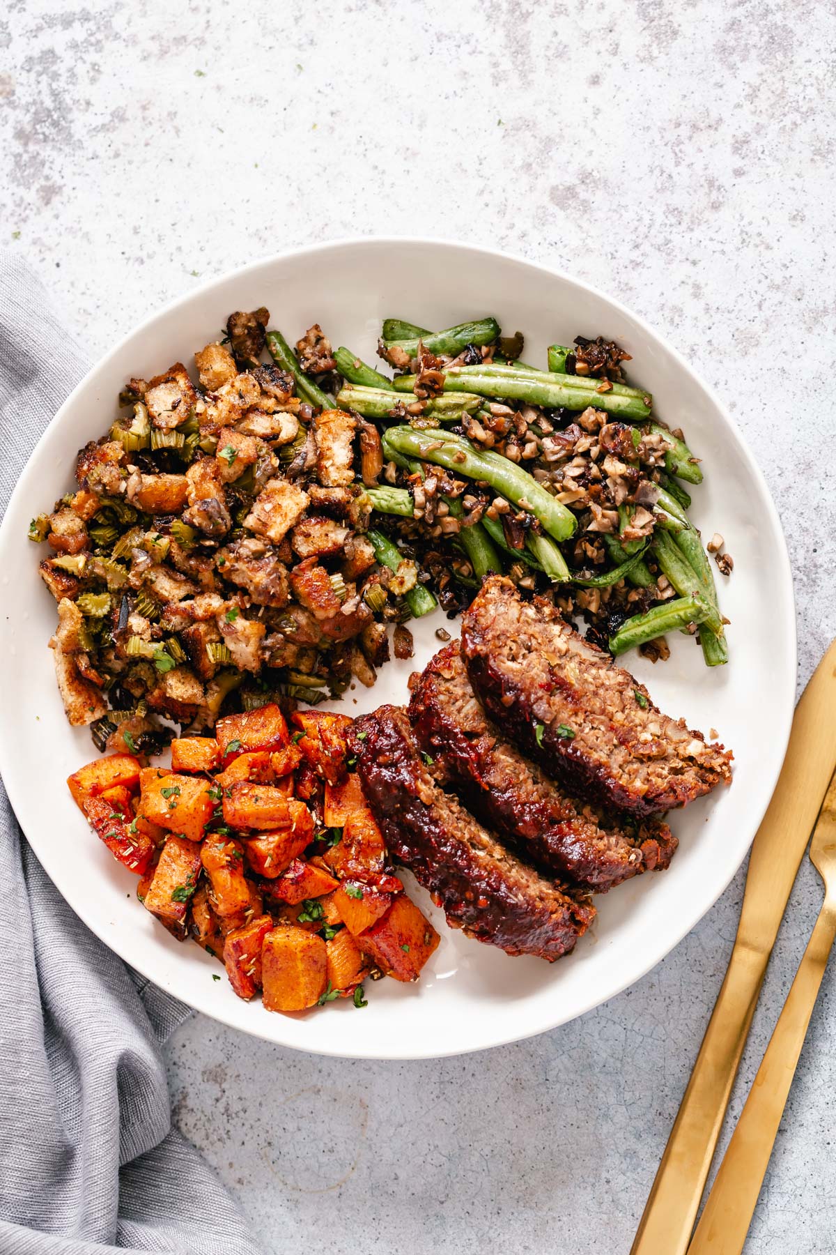 Thanksgiving sheet pan dinner vegan lentil loaf, sweet potatoes and green beans on a plate