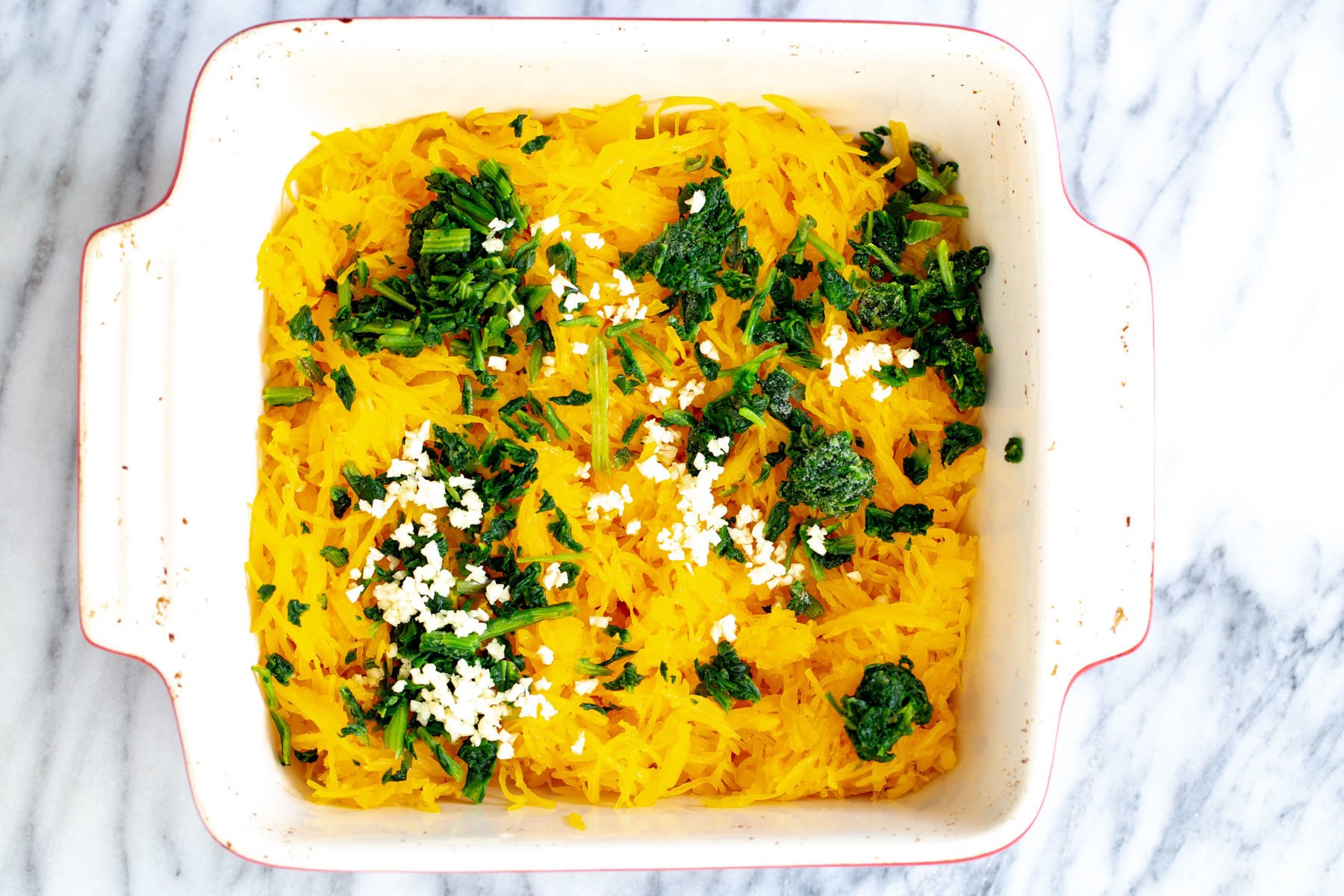 spaghetti squash bake  cooked spaghetti squash, spinach and garlic in a white casserole dish