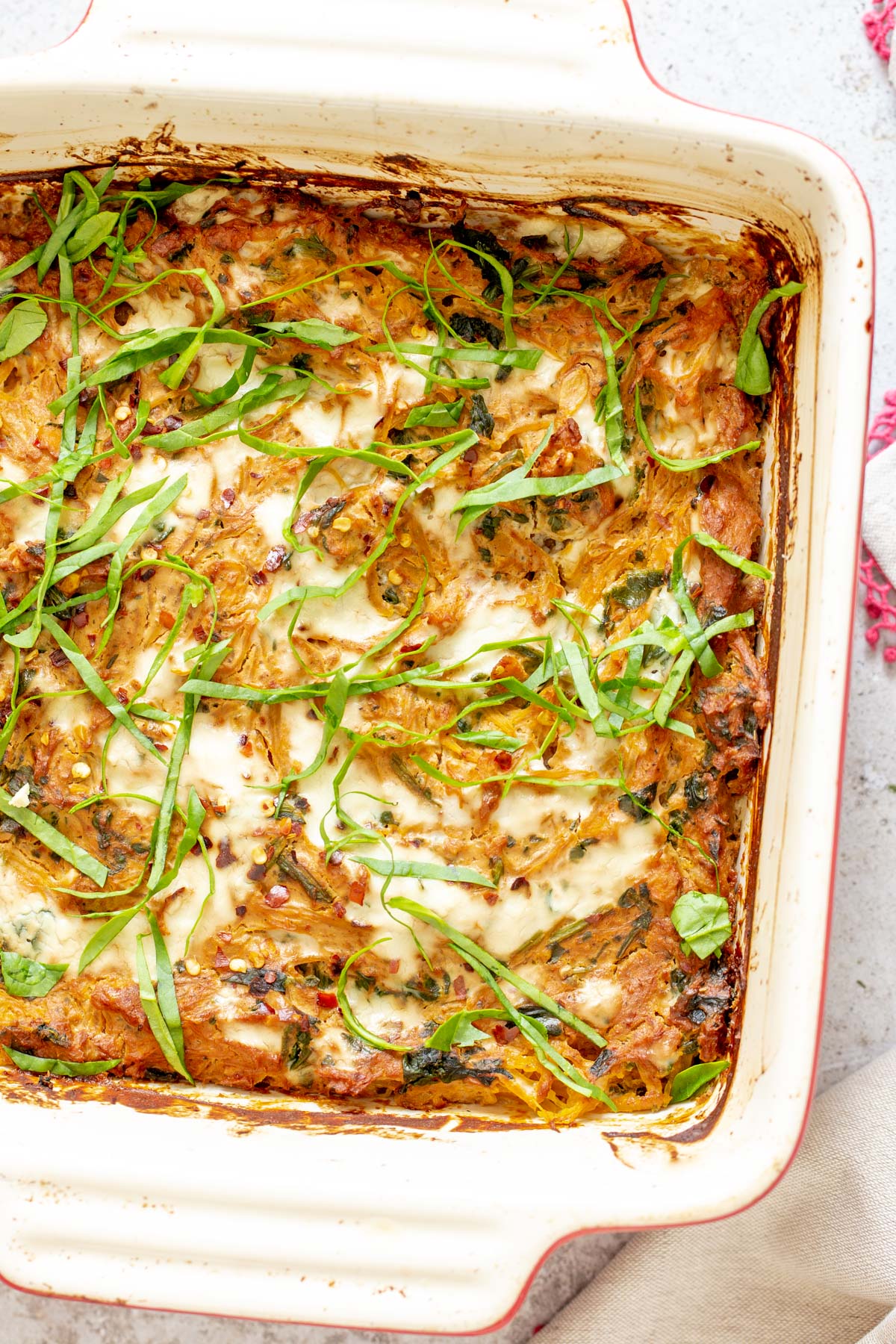 spaghetti squash bake  vegan Italian Sun-dried tomato Spaghetti Squash Pasta Bake in a white casserole dish