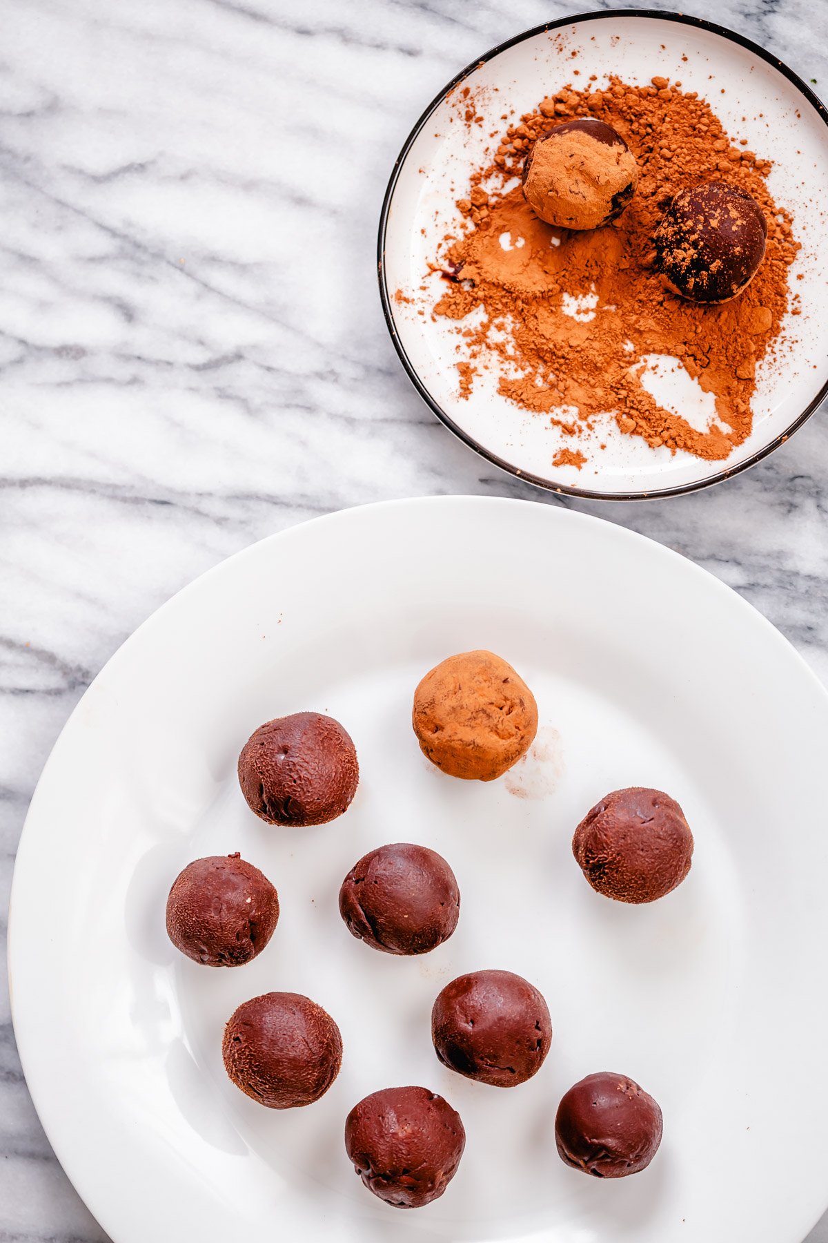 tiramisu truffles vegan tiramisu truffles being rolled in cocoa powder