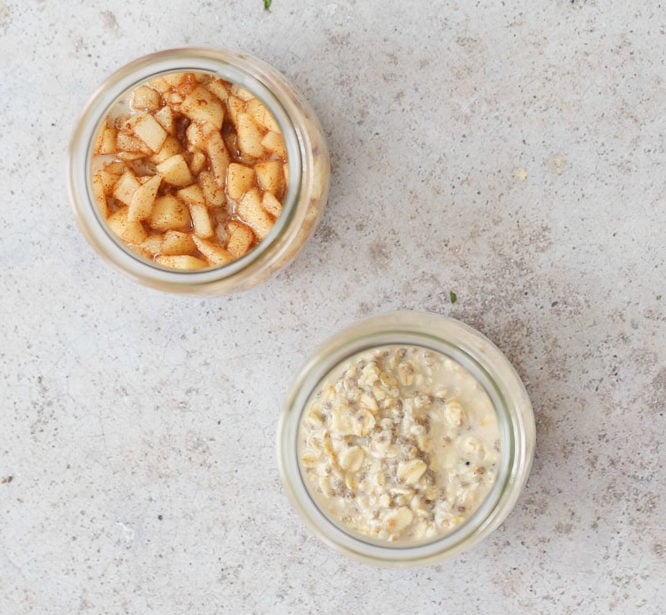 two half filled mason jars with apple cinnamon oatmeal
