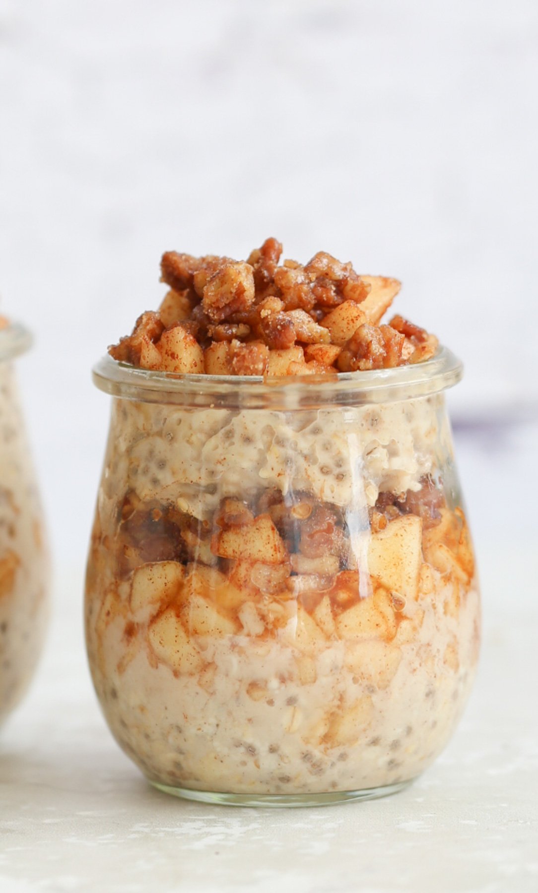 side view of a mason jar with vegan apple cinnamon overnight oats 