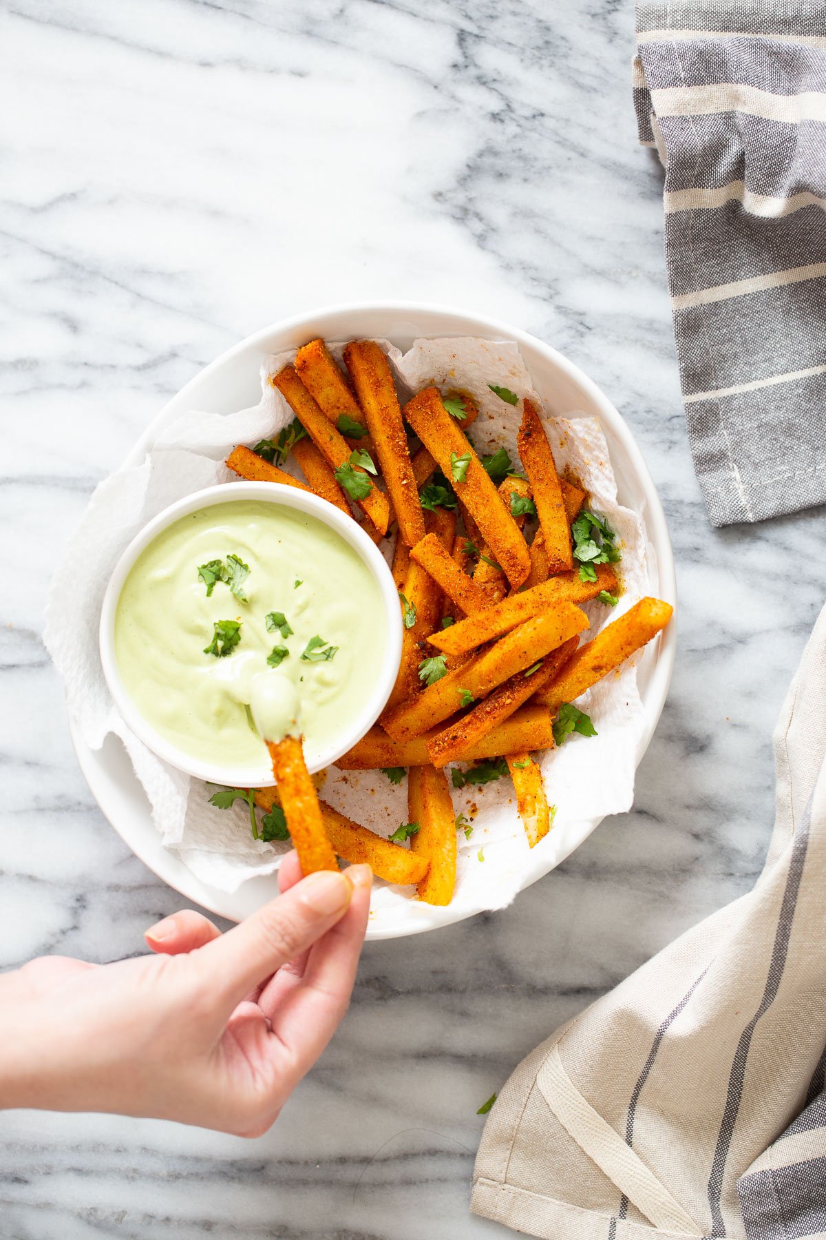 chickpea fries a chickpea flour frie being dipped into a cashew based cilantro lime dip