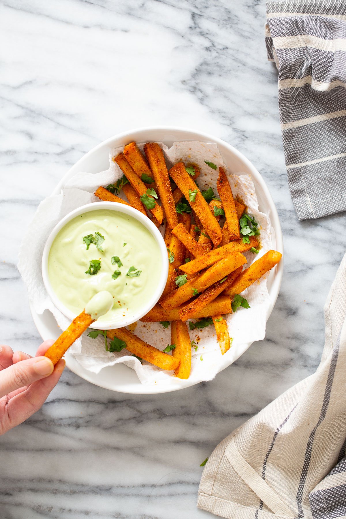 chickpea fries a vegan chickpea flour frie being dipped into cilantro lime dip