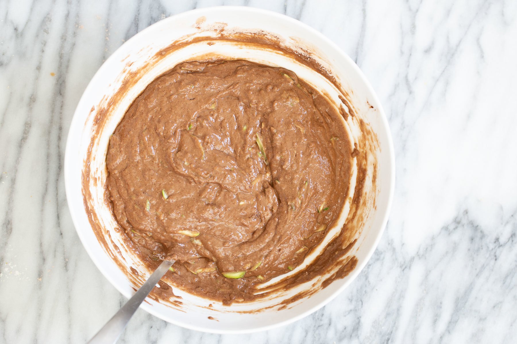 chocolate zucchini bread chocolate zucchini cake batter in a white bowl