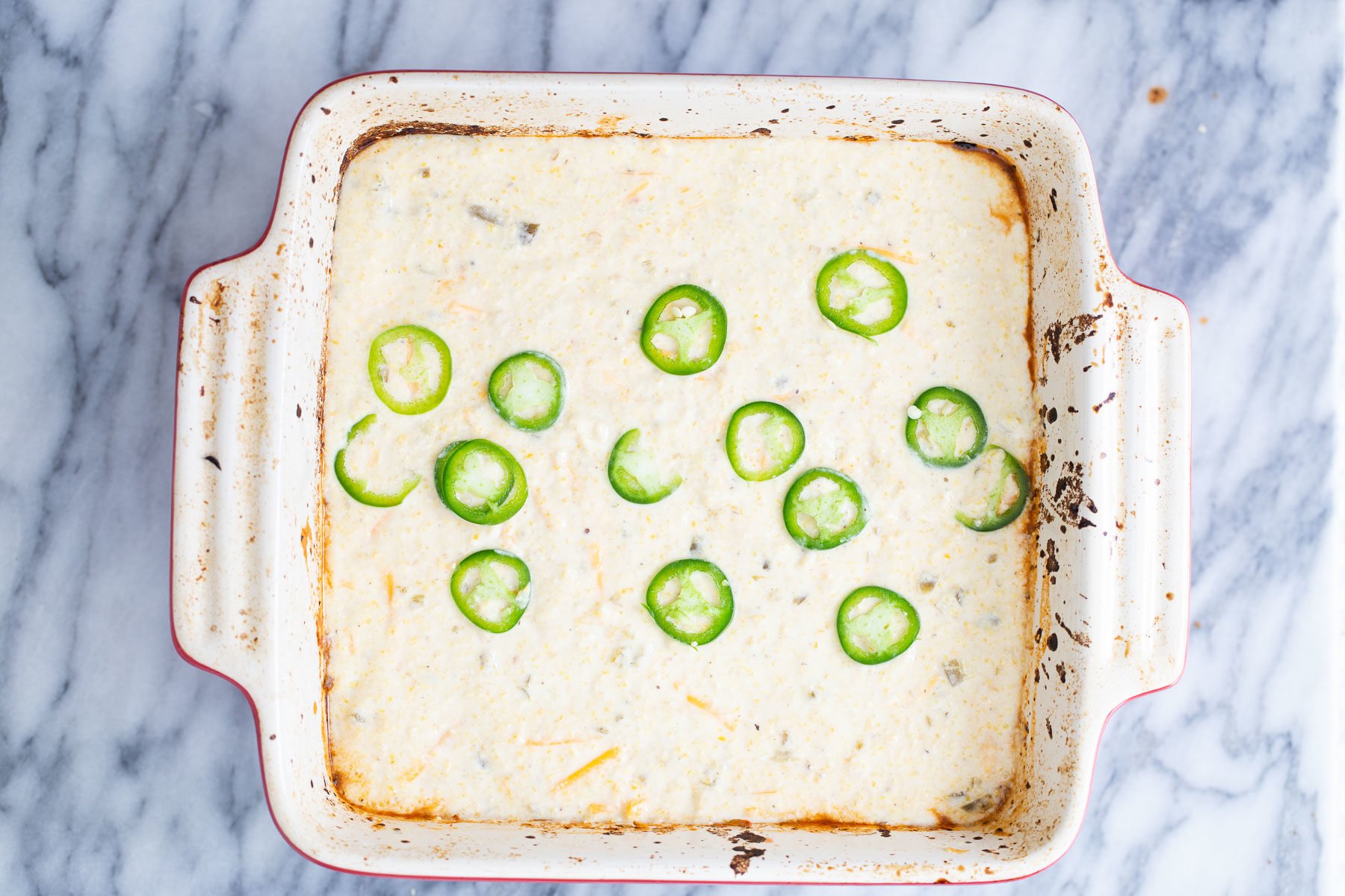 chili cornbread casserole chili cornbread casserole topped with jalapeno rounds