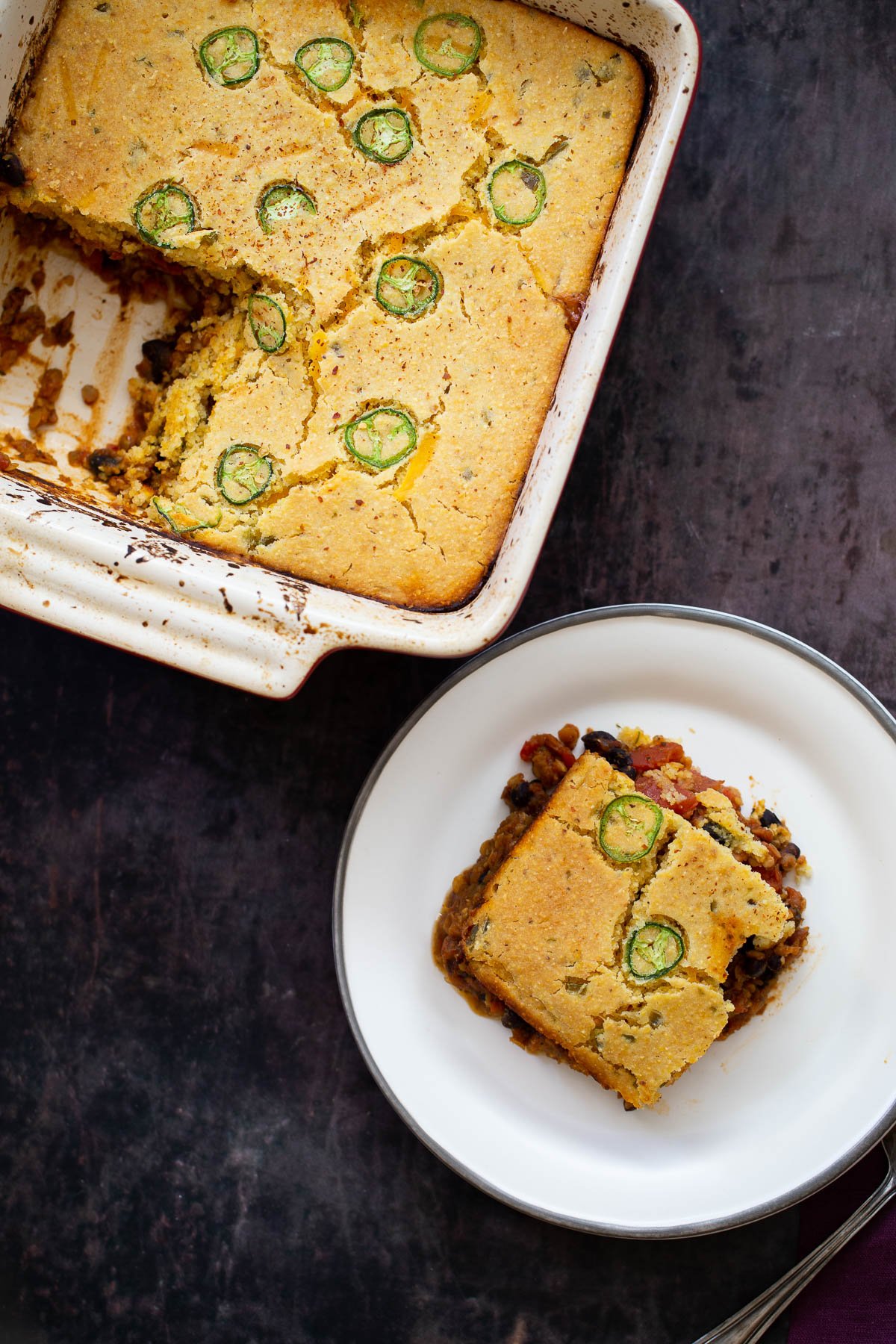 chili cornbread casserole overhead shot of a chili cornbread casserole with one square cut an served