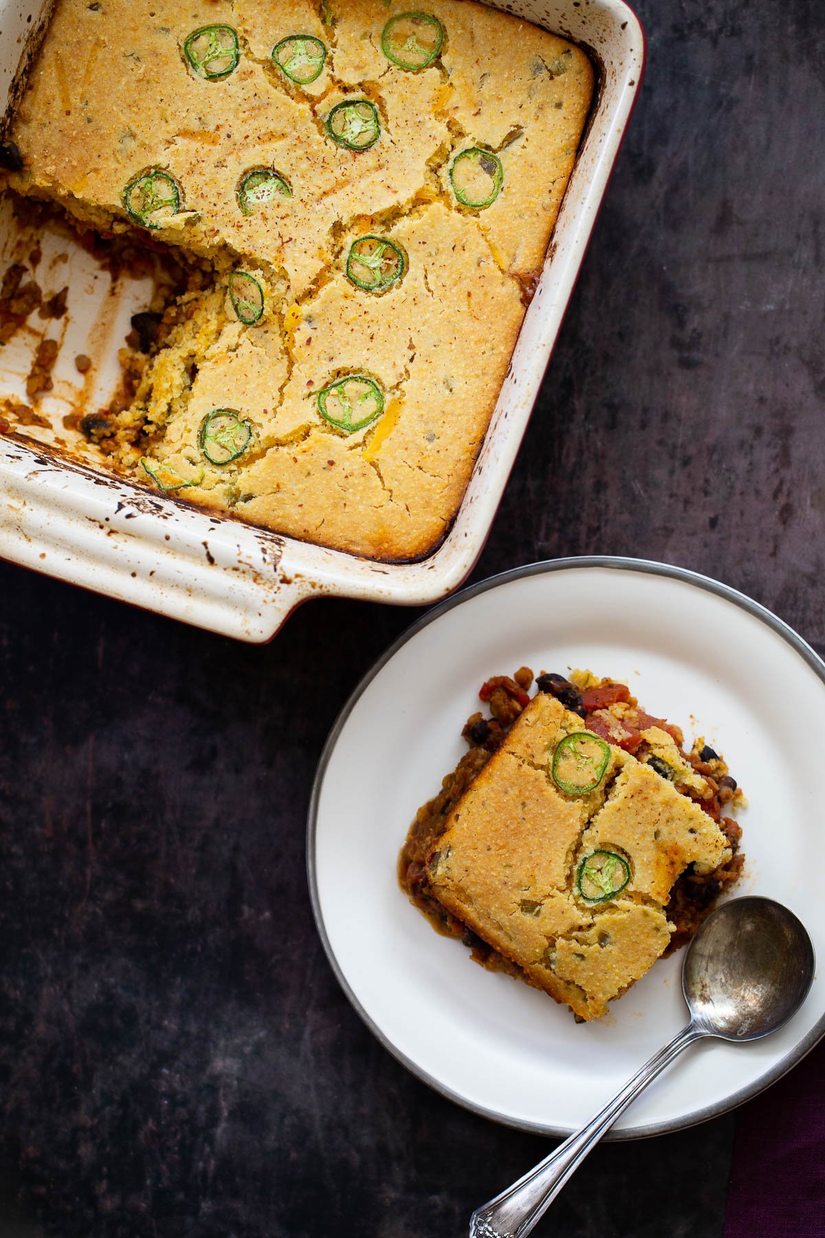 chili cornbread casserole overhead shot of chili cornbread casserole with one square cut