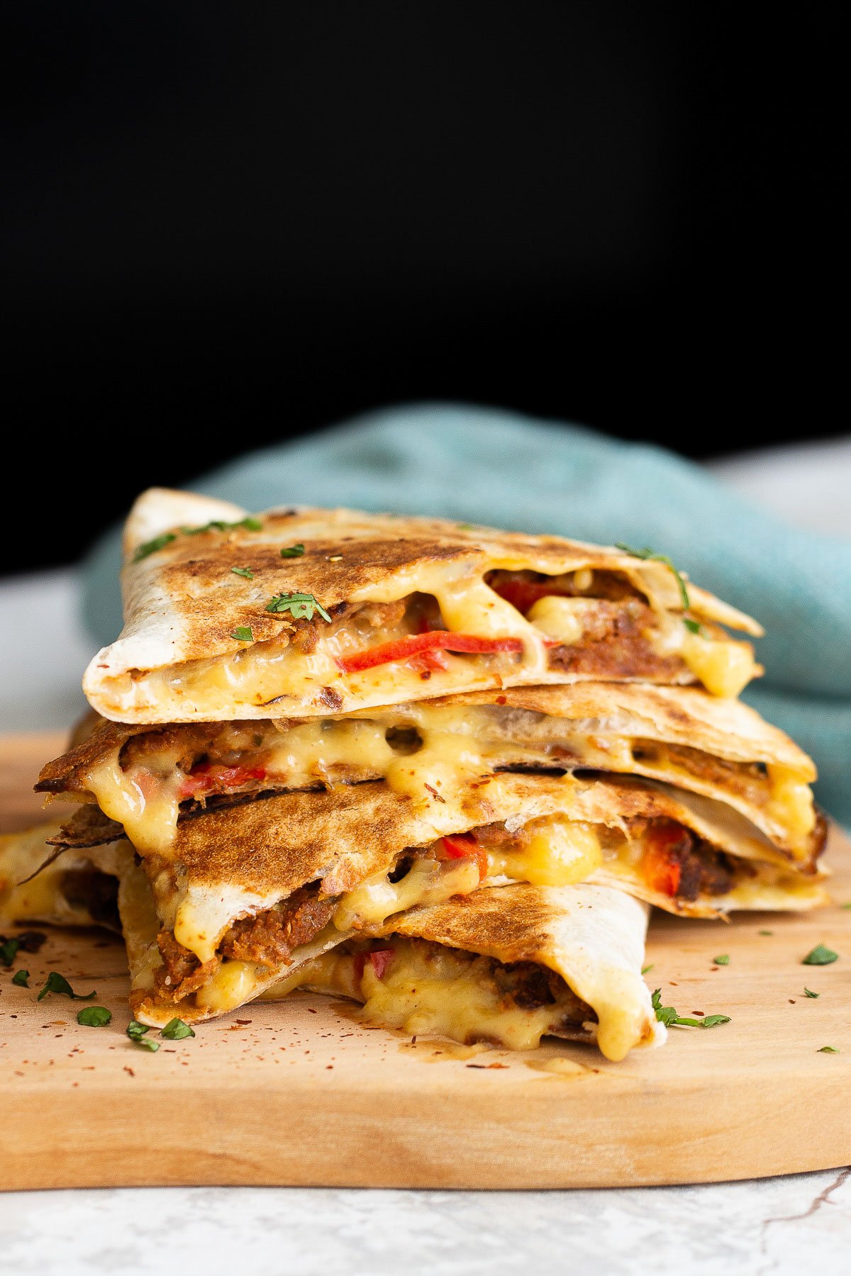 walnut taco meat close-up side view of a stack of cut vegan walnut meat quesadillas