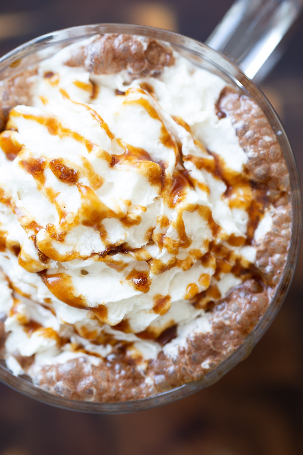 salted caramel mocha  overhead shot of a mug of vegan salted caramel mocha topped with whipped coconut cream and caramel syrup