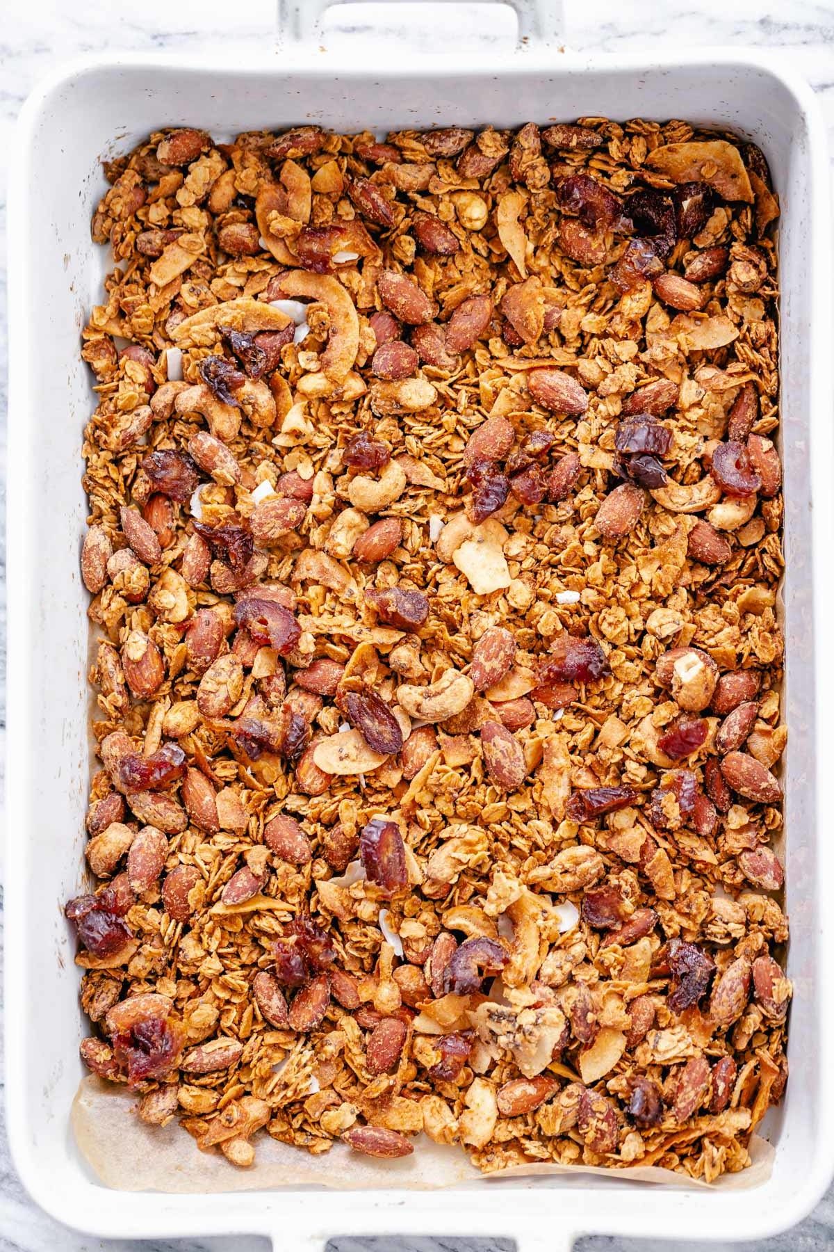 coconut granola overhead shot of vegan baked coconut almond granola in a casserole dish
