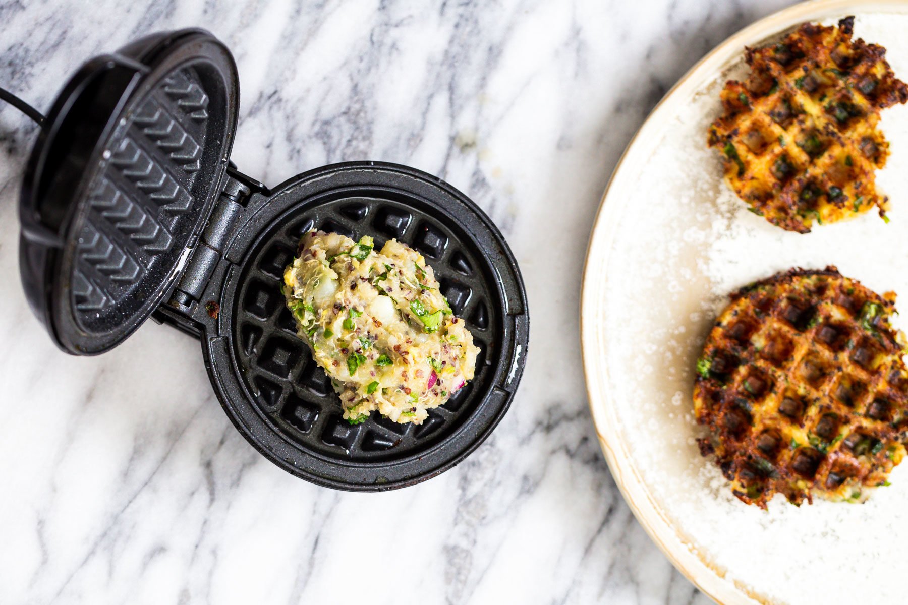vegan quinoa waffles Indian spiced crispy vegan potato quinoa waffles being baked in a waffles iron