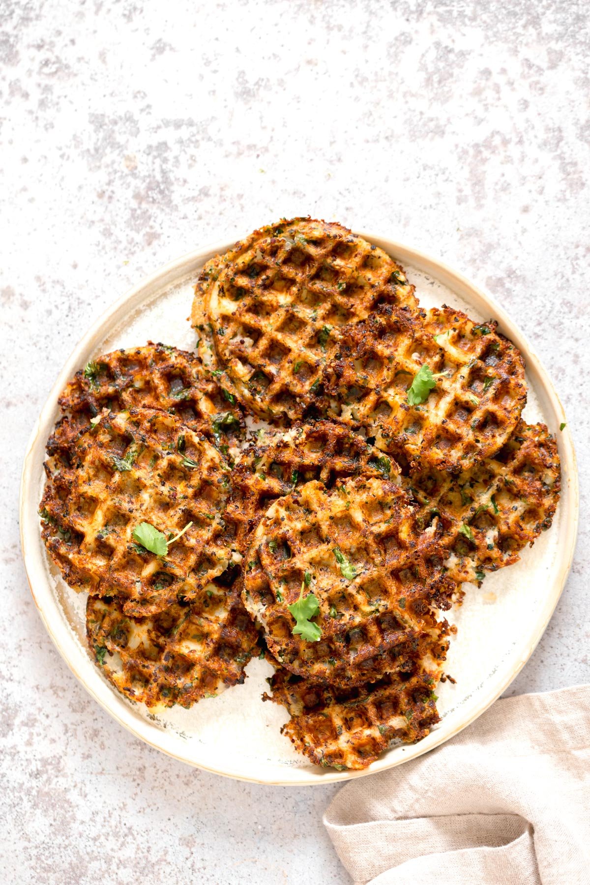 a plate of crispy vegan potato quinoa waffles