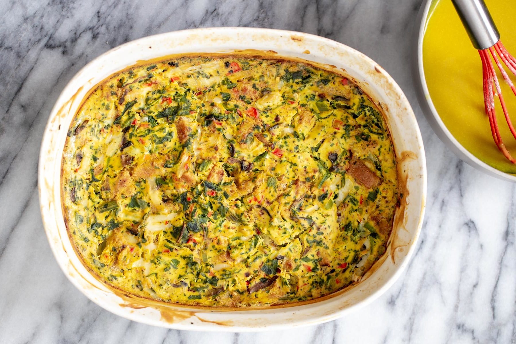 freshly baked vegan breakfast casserole in a white ceramic baking dish