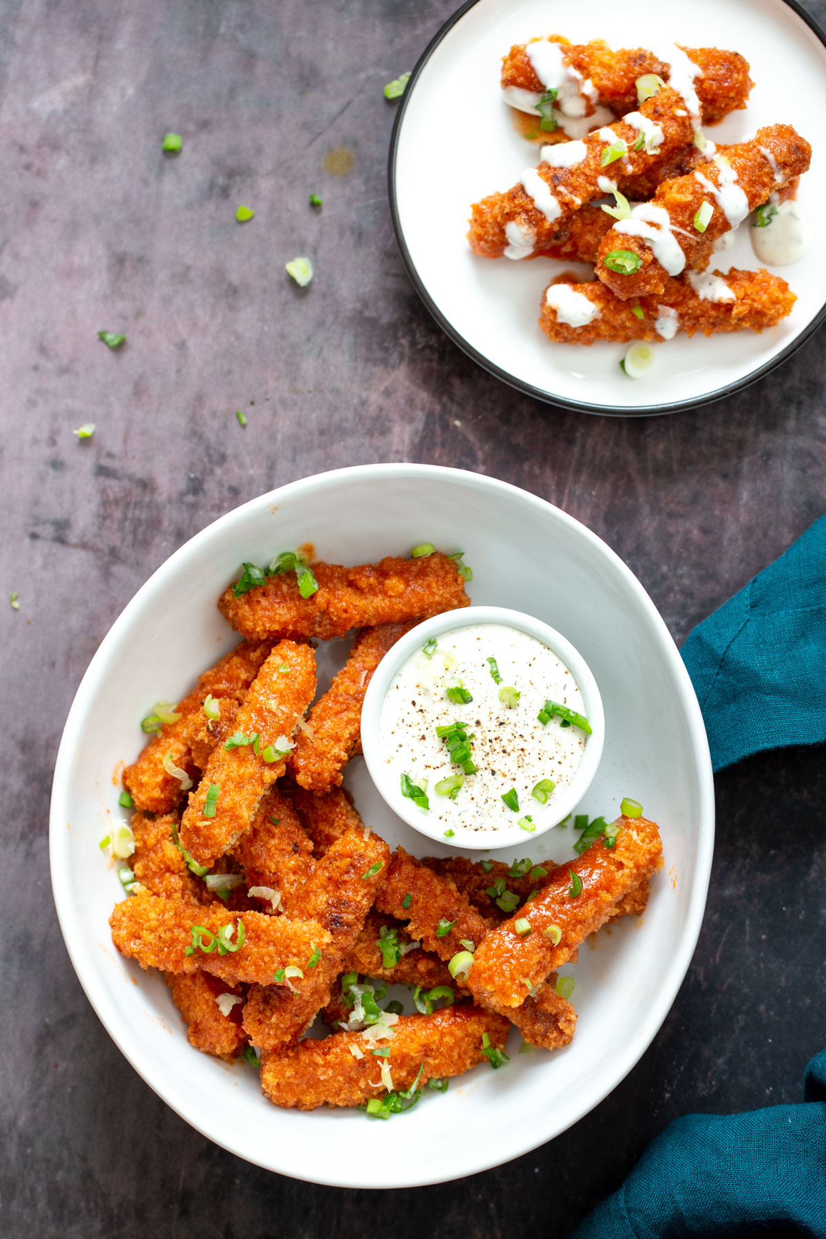 tofu wings  two plates with vegan baked firecracker tofu wings served with vegan ranch