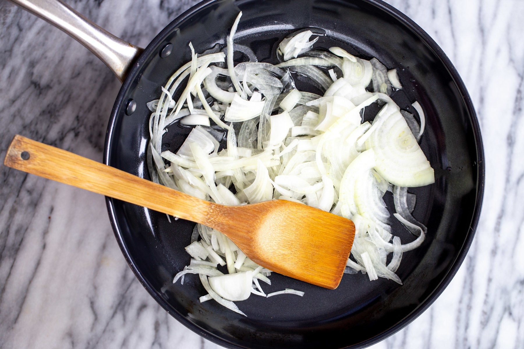 vegan skillet lasagna  onion slices in a black skillet