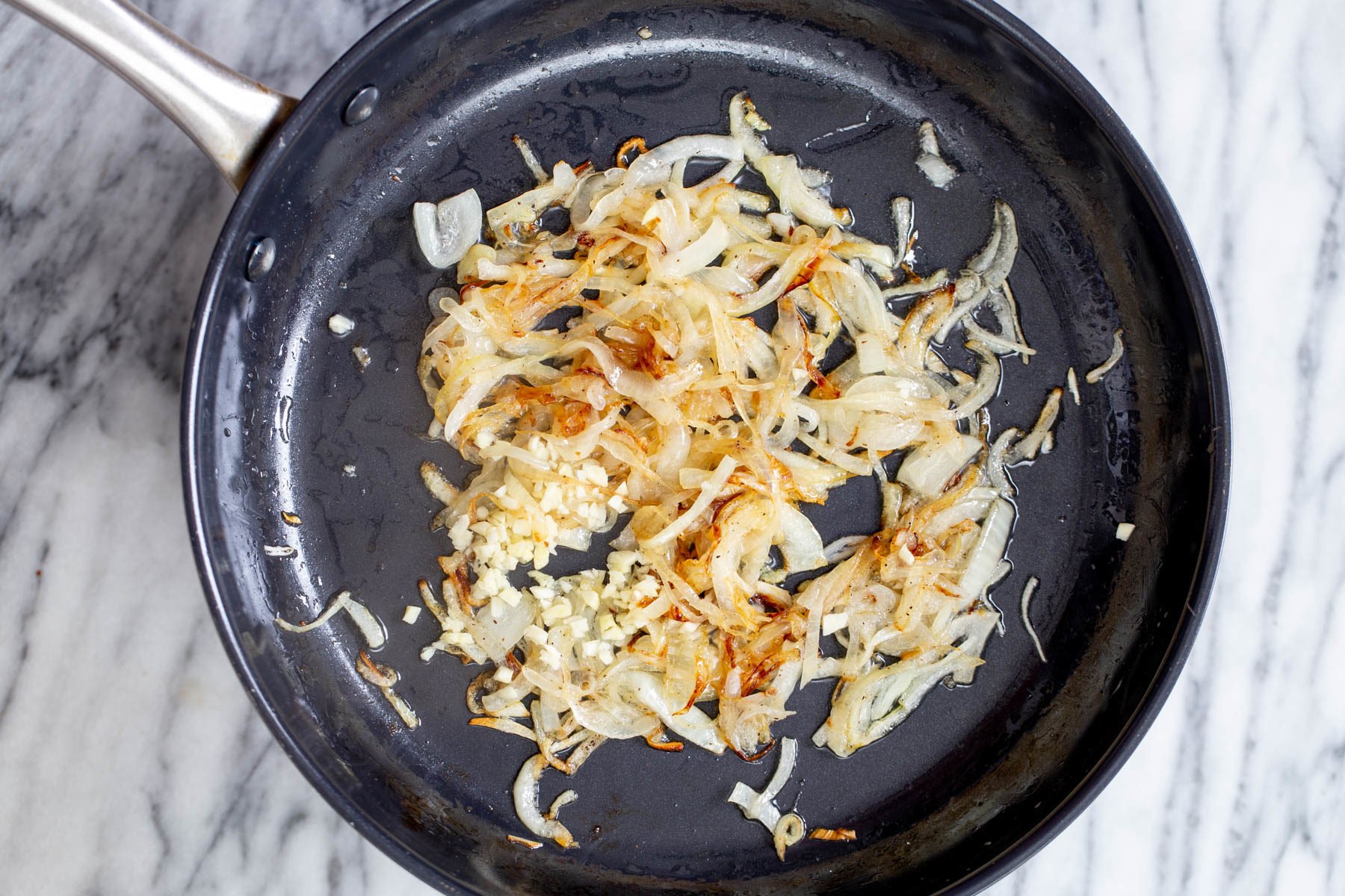 vegan skillet lasagna  slightly golden sauteed onion sliced in a skillet