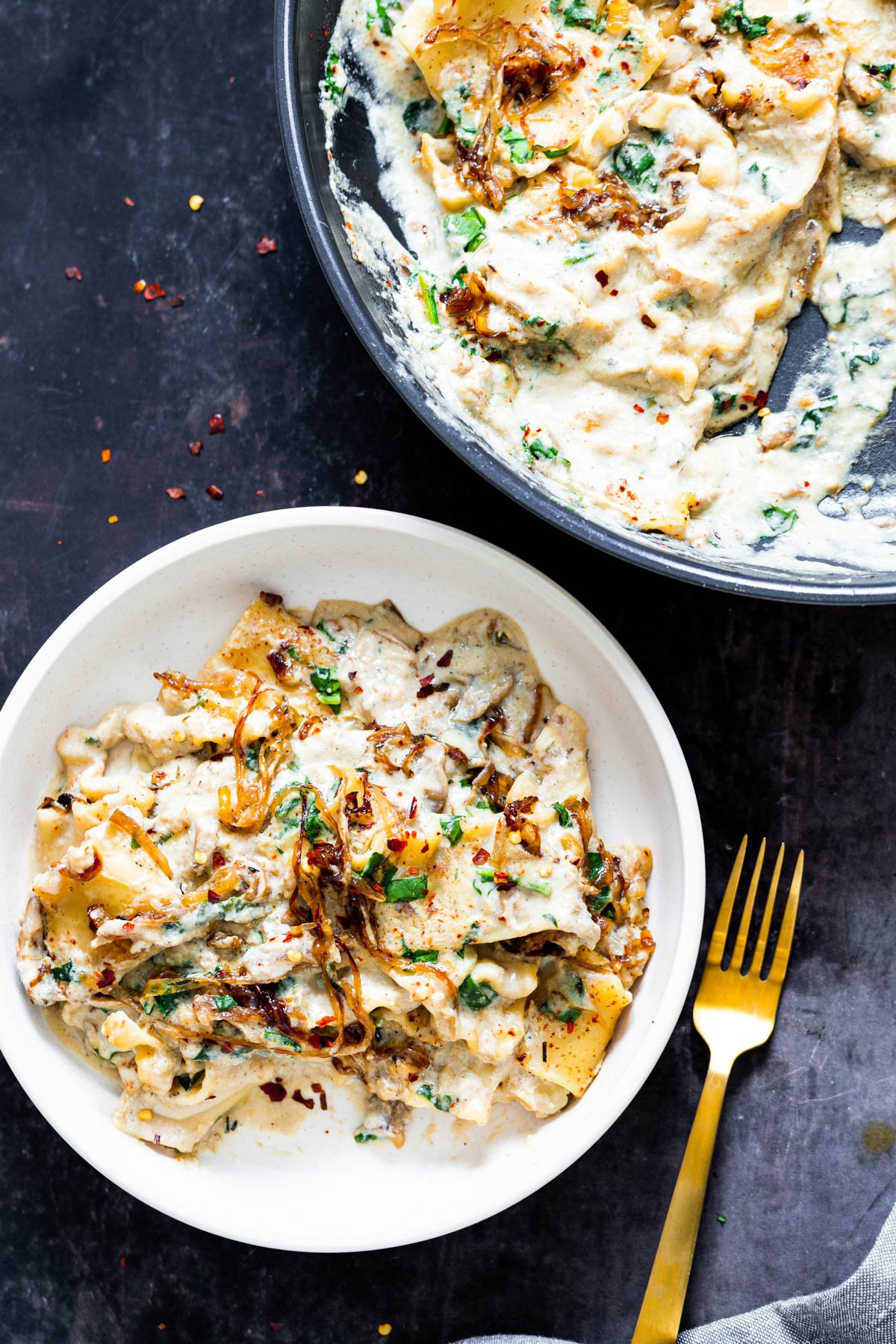 vegan skillet pasta  a white bowl with one skillet French Onion Lasagna with spinach and vegan bechamel