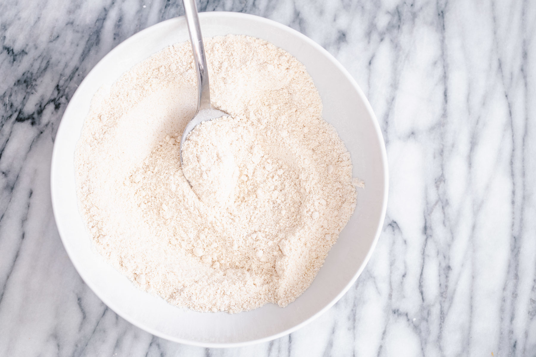 glutenfree donuts recipe dry mix for making glutenfree vanilla donuts in a white bowl