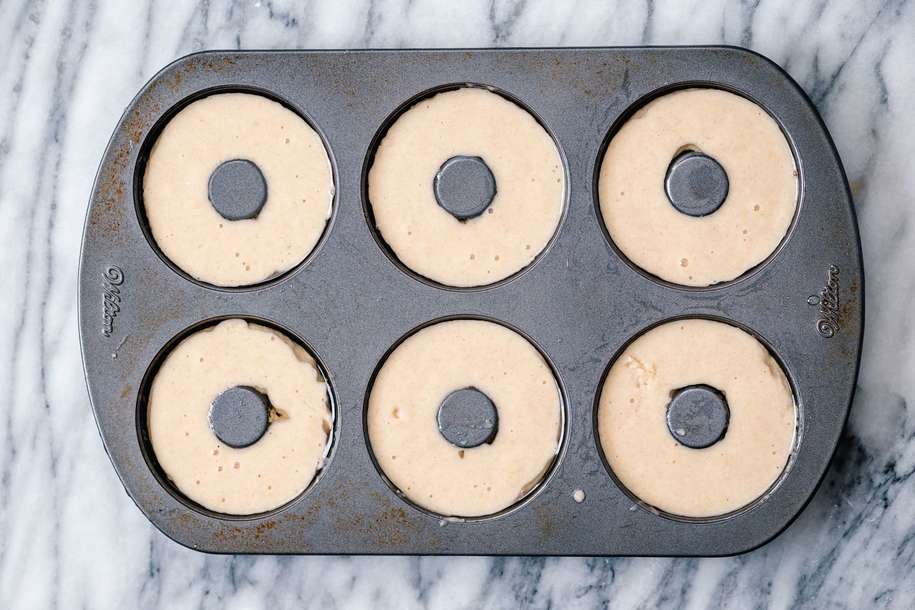 glutenfree donuts recipe glutenfree almond flour donuts batter being filled into donuts pan