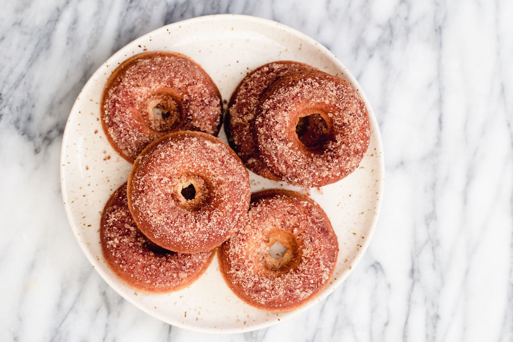 glutenfree donuts recipe  freshly baked glutenfree vanilla donuts on a white plate